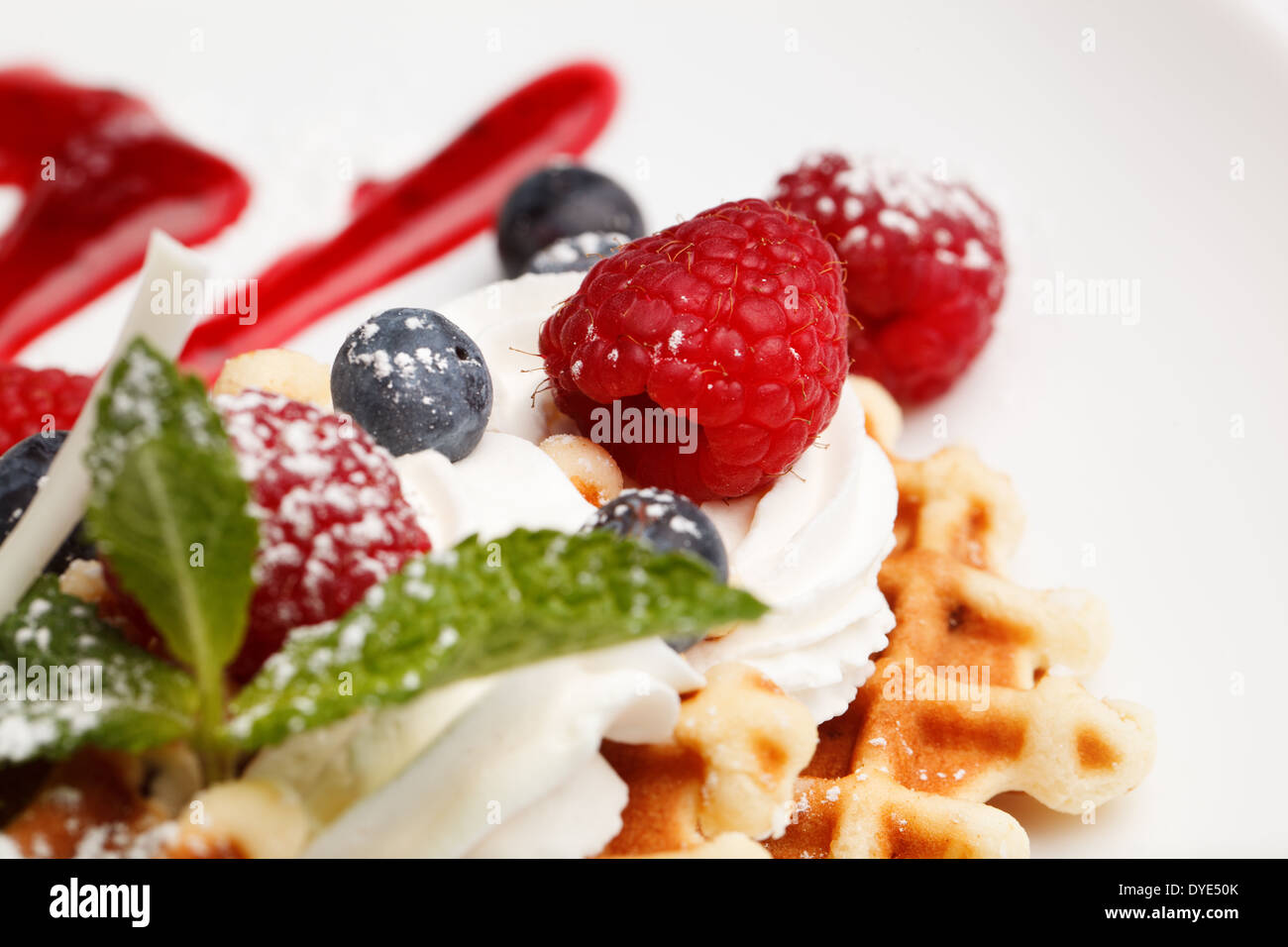 Waffle and cream topped with fresh berries Stock Photo - Alamy