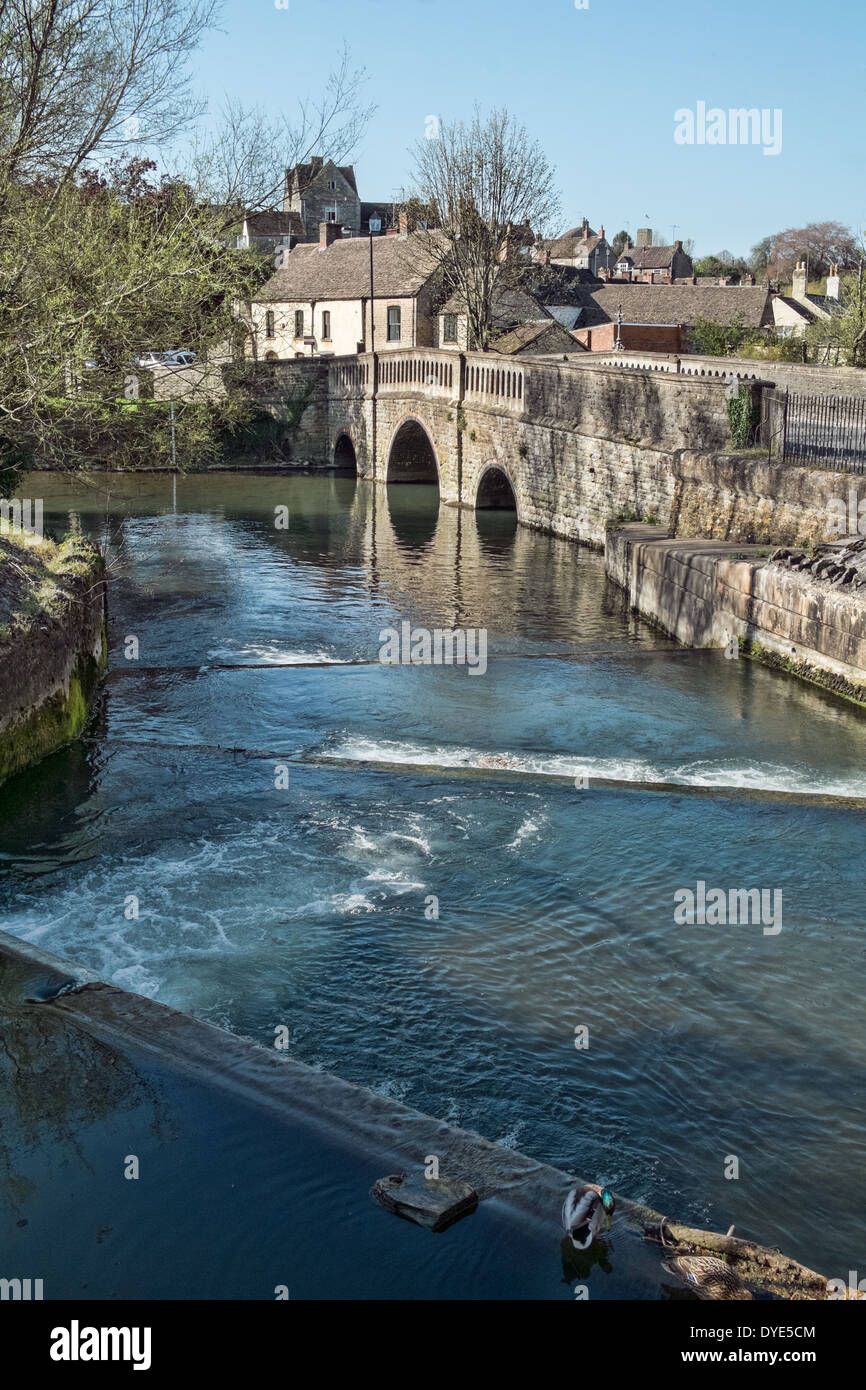 The flowing river Avon passing over the weir & under the bridge at the Southern entrance to Malmesbury, Wiltshire, UK Stock Photo