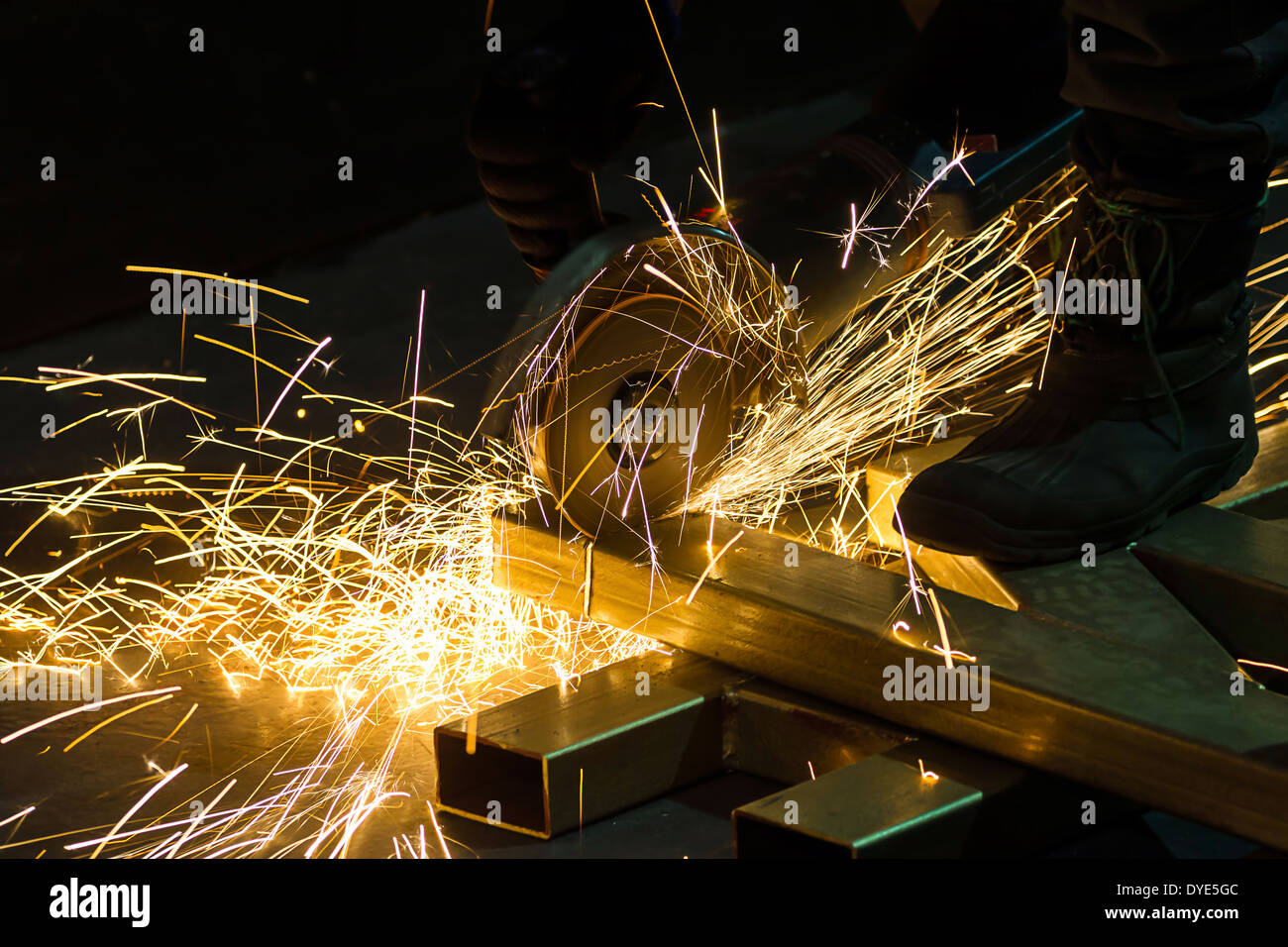 sharpening and cutting of iron by abrasive disk machine Stock Photo - Alamy