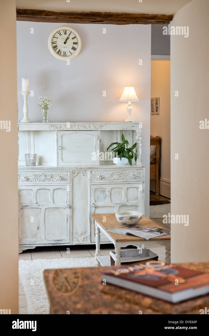 A staged lifestyle image of a white shabby chic dresser in a small ante room Stock Photo