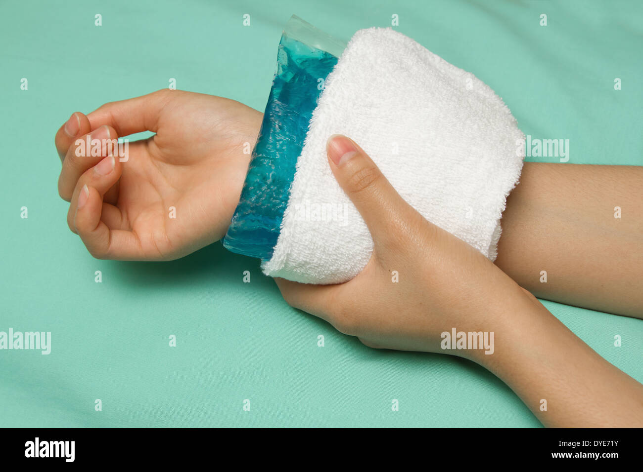 a woman applying cold pack on swollen hurting wrist after accident Stock Photo Alamy