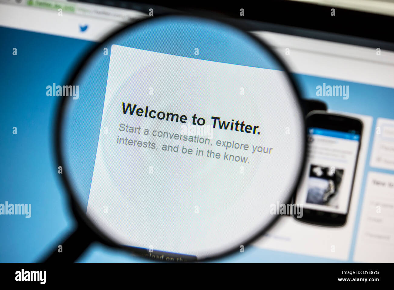 Twitter website under a magnifying glass. Stock Photo