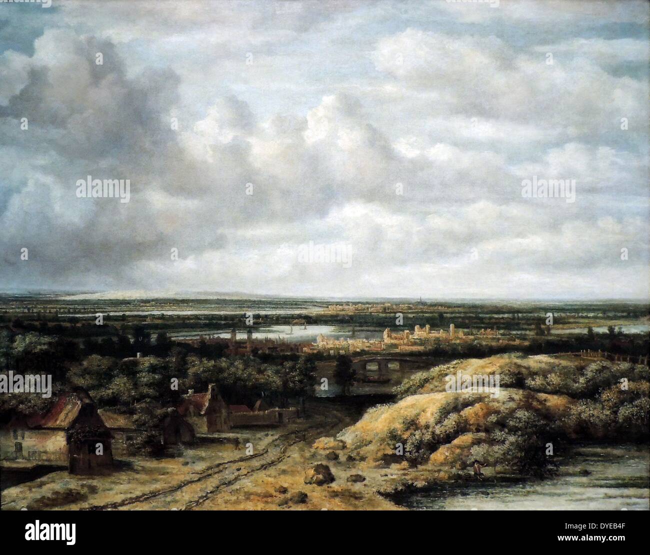 Distant view with Cottages along a Road by Philips Koninck (1619-1688) oil on canvas, 1655. A few dunes provide the only relief in this otherwise sweeping landscape stretching out under a vast sky. Koninck specialized in flat landscapes, which he built up with countless dots, like the knots in a tapestry. His palette and loose painting style reveal the influence of Rembrandt. The three cottages at the left are based on an etching by Rembrandt from 1650. Stock Photo