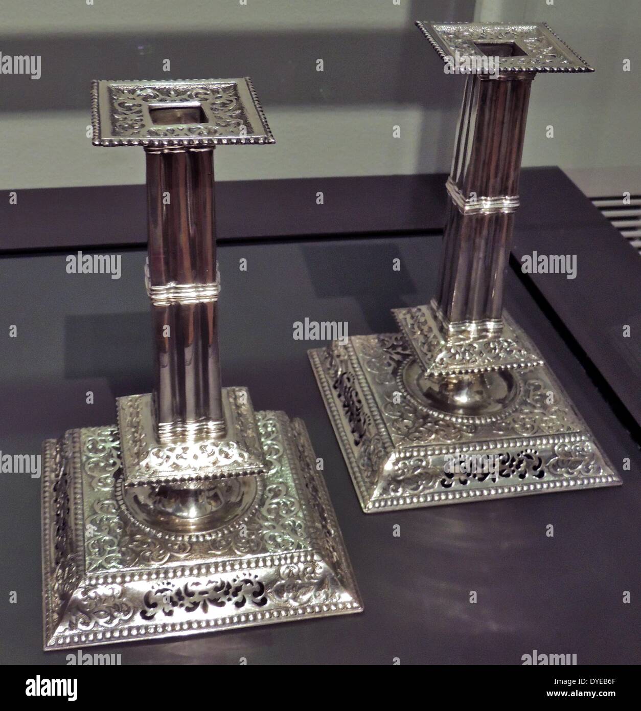 Pair of candlesticks attributed to Jan van Cloon, Batavia (now Jakarta), before 1730, silver. In Batavia, Dutch silversmiths worked alongside Chinese, Indian and local craftsmen. These candlesticks bear the hallmarks of Batavia and the marks of a master IVC, possibly Jan van Cloon. His candlesticks have no Asian features and closely follow European models. Stock Photo