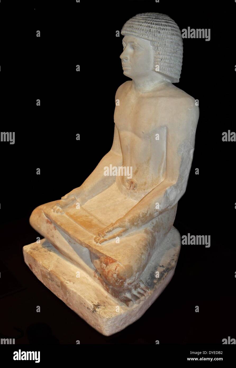 Scribe seated cross-legged, a papyrus on his knees 2350 B.C. Stock Photo
