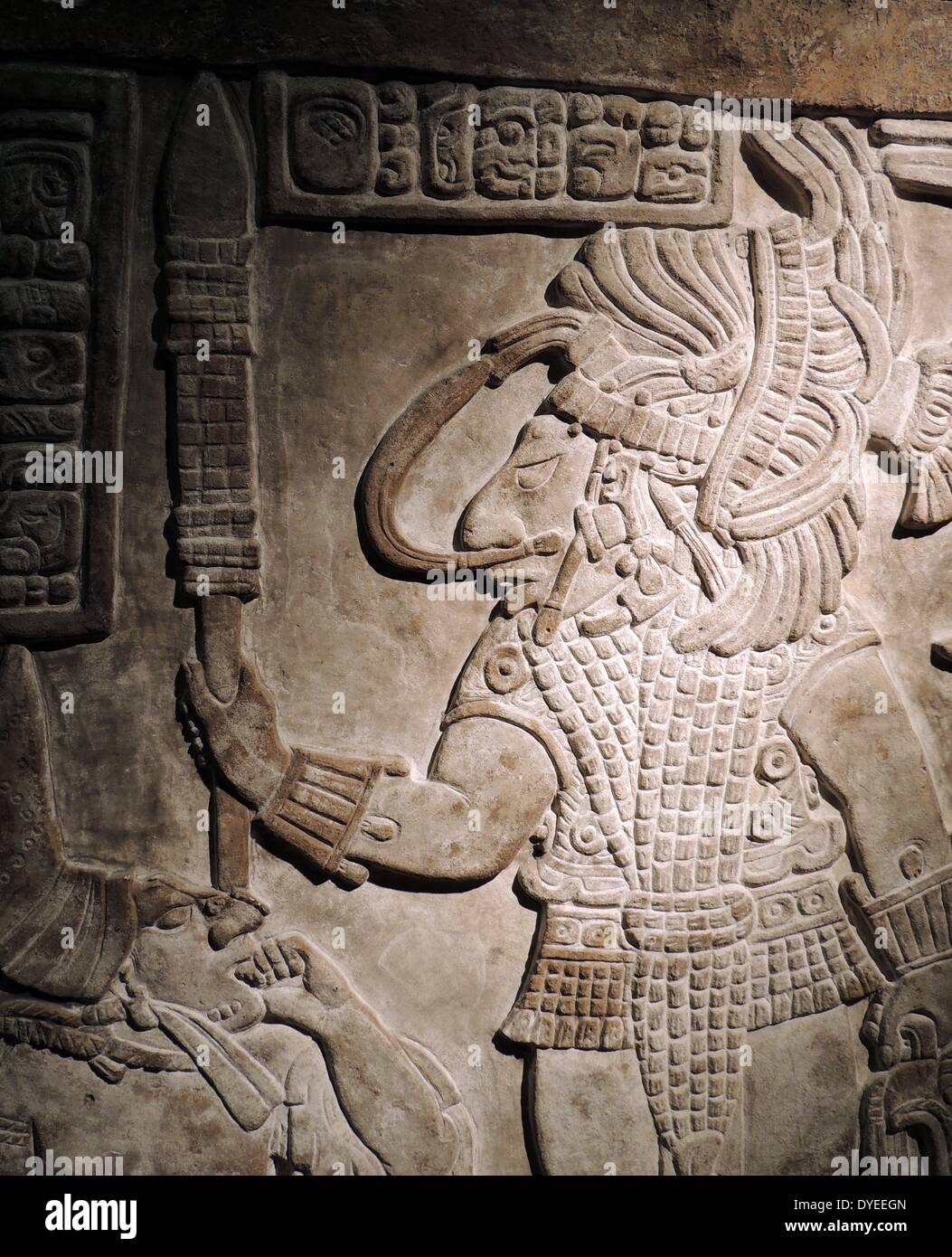 Mayan relief showing the sumptuously dressed kneeling woman pulling the  rope through her tongue is Lady Balam-IX, another one of Bird Jaguar's  wives. Opposite her sits Bird Jaguar, adorned with ornate earplugs,