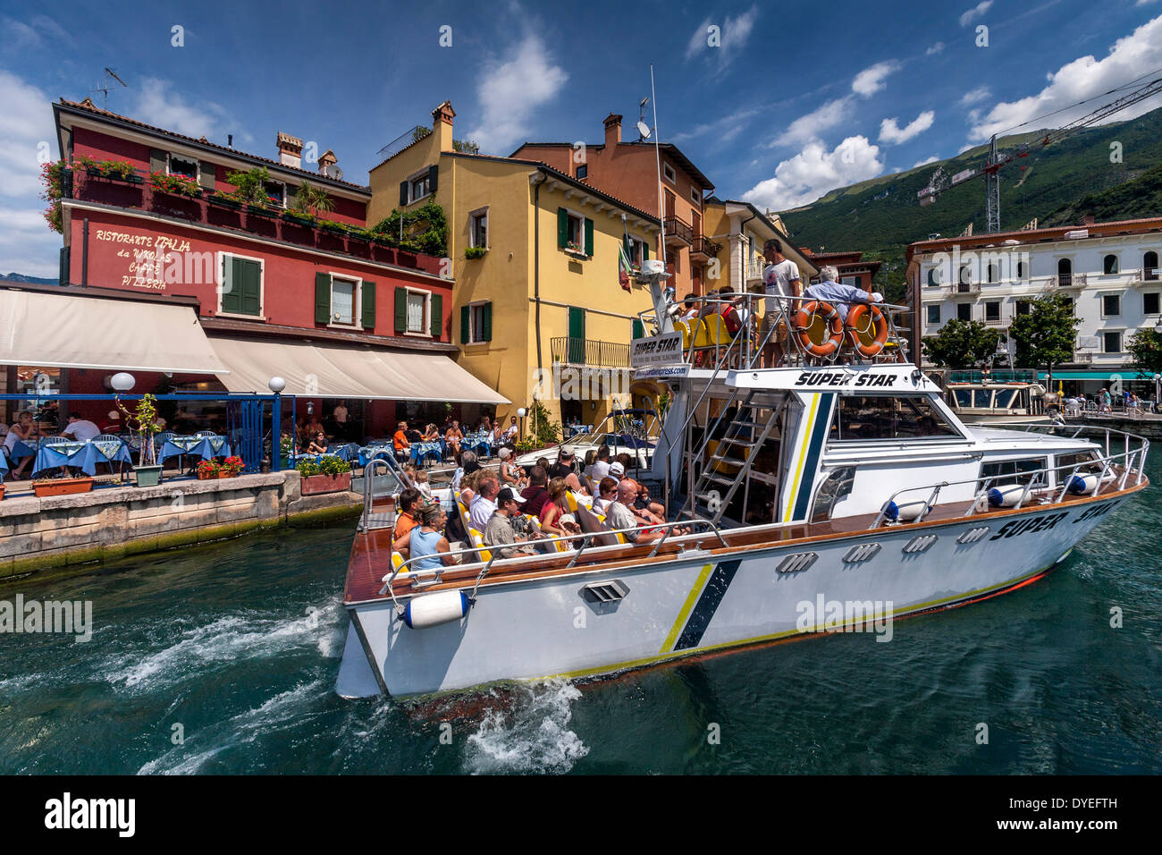 Tourists Taking A Boat Trip, Malcesine, Lake Garda, Italy Stock Photo