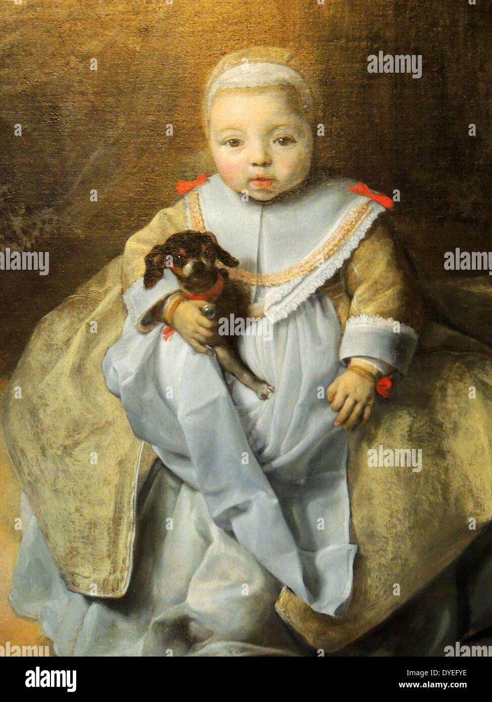 little boy holding dog painting