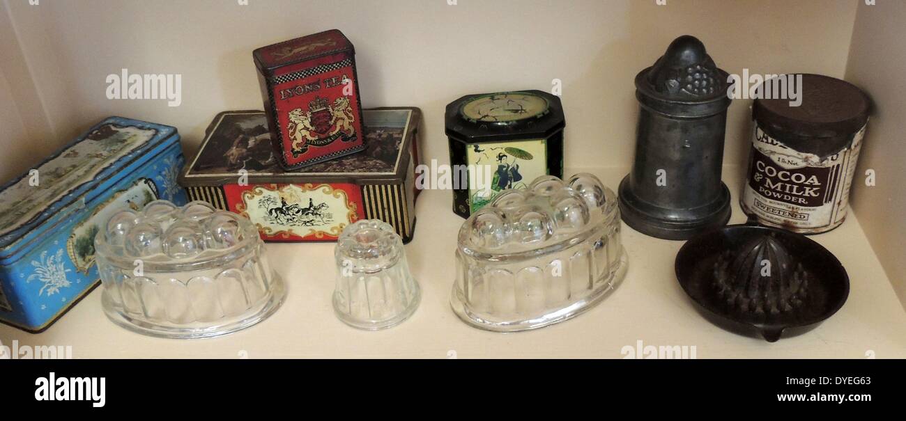 Selection of tins containing cocoa and tea together with a lemon juice squeezer and jelly moulds dated to 1920's Stock Photo
