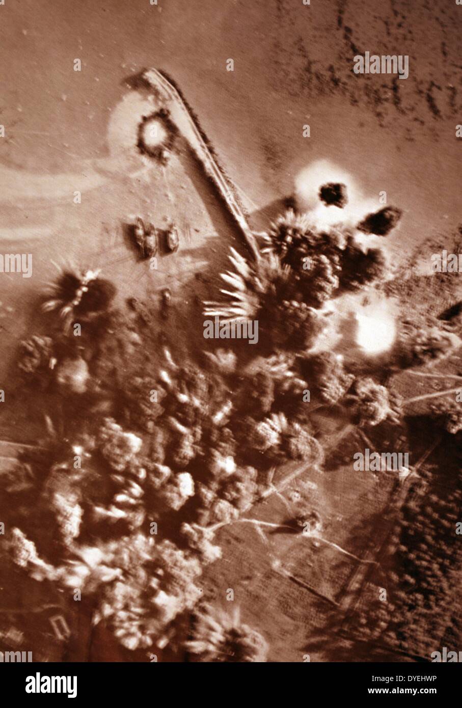 Bombing Brest, France - U.S. Army Forces. Small craft, gun emplacements and a quay on the Brest Peninsula took a pounding from England-based U.S. Army 8th Air Force bombers several weeks after D-Day, 1944. The camera caught the bombs in various stages of exploding and at the same time recorded the success of the mission. Underwater defences can be seen at the lower right. Stock Photo