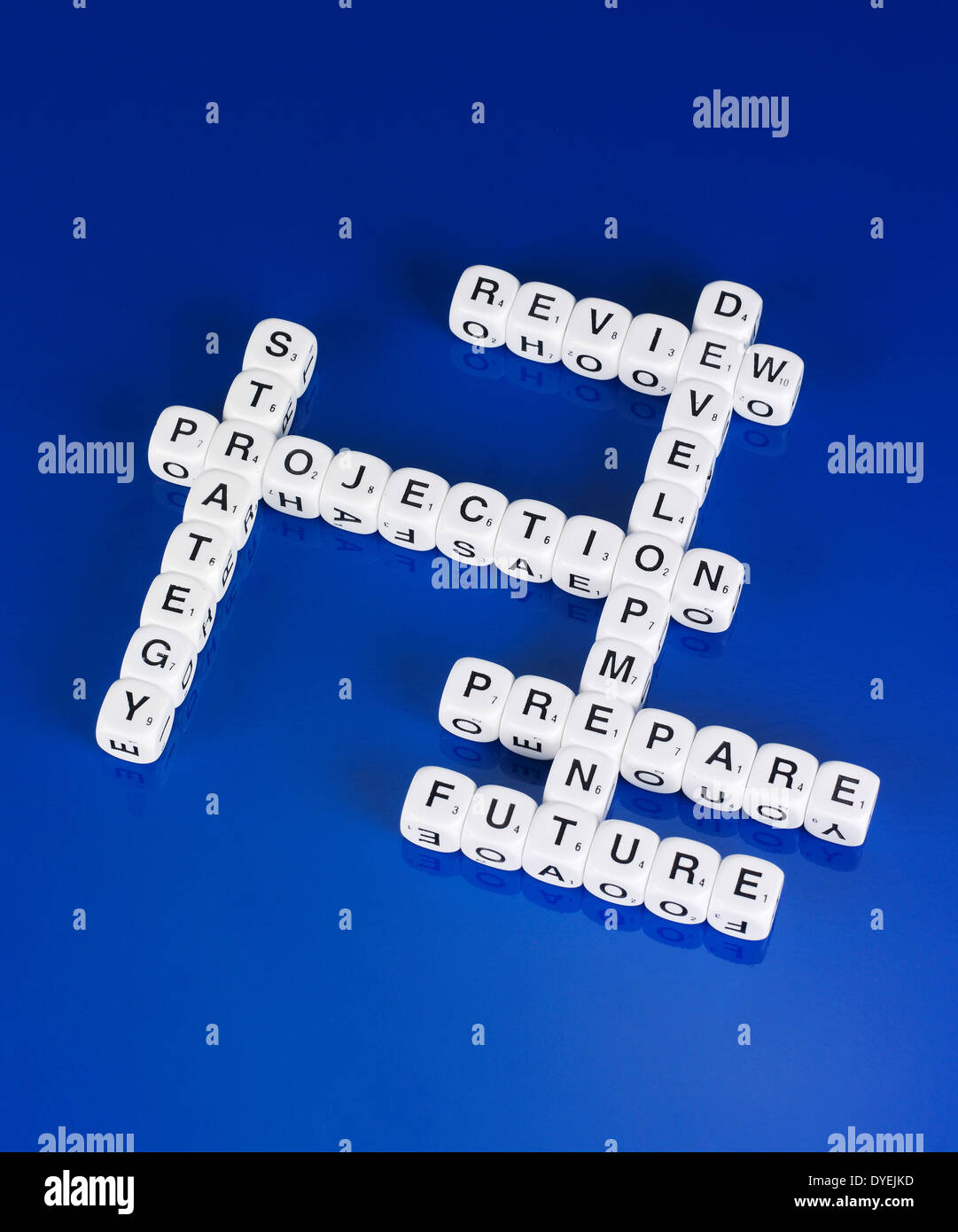 DICE SPELLING OUT WORDS IN A SCRABBLE LIKE FORMATION ON A BLUE BACKGROUND Stock Photo