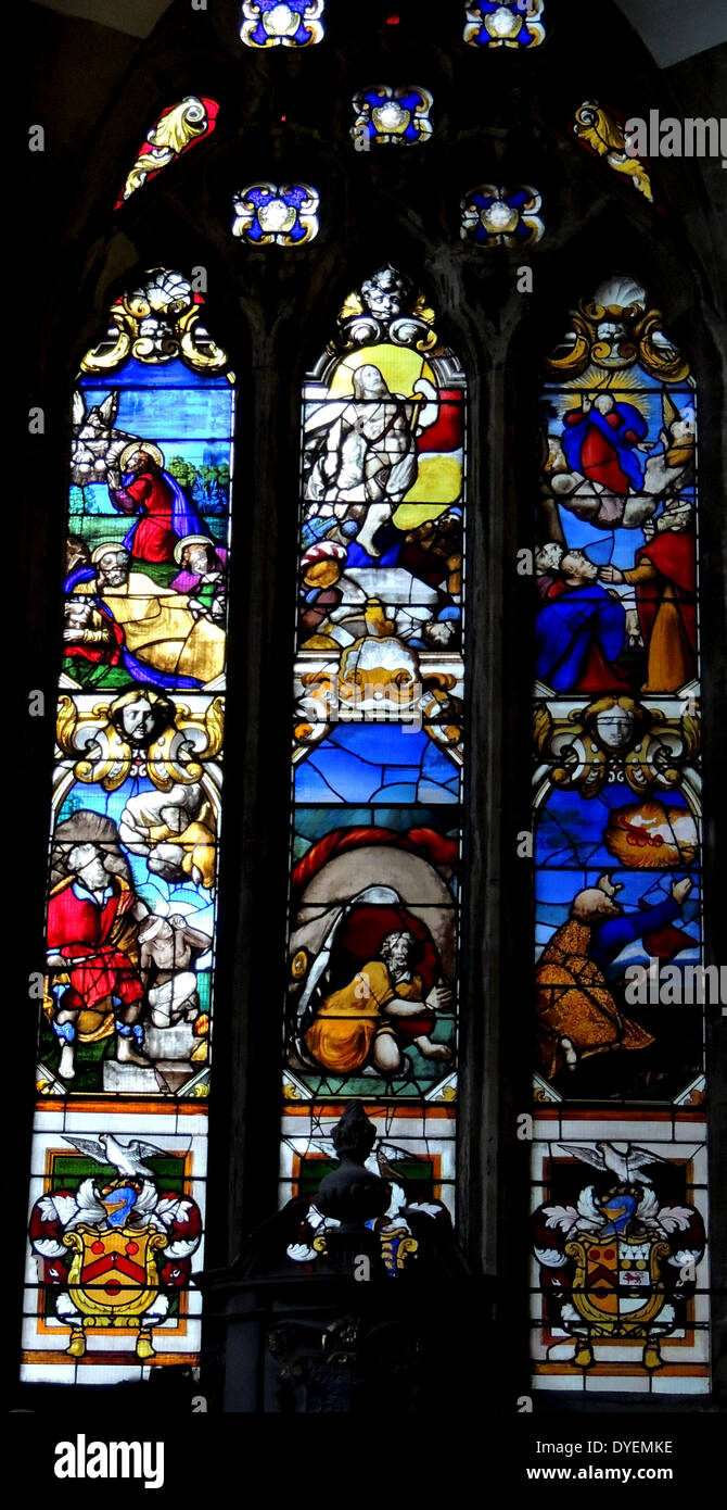 The Glemham window, stained glass window at Bristol Cathedral, England. This window was one of a pair; the other formerly to be found on the south side but of which only fragments remain after the 1940 bombing. It depicts various episodes from the bible including: Gethsemane, The Resurrection, The Transfiguration, Abraham & Isaac, Jonah swallowed by the whale, Elijah ascending to heaven in a chariot and at the bottom the Coats of arms of the Glemham family and their alliances. Stock Photo