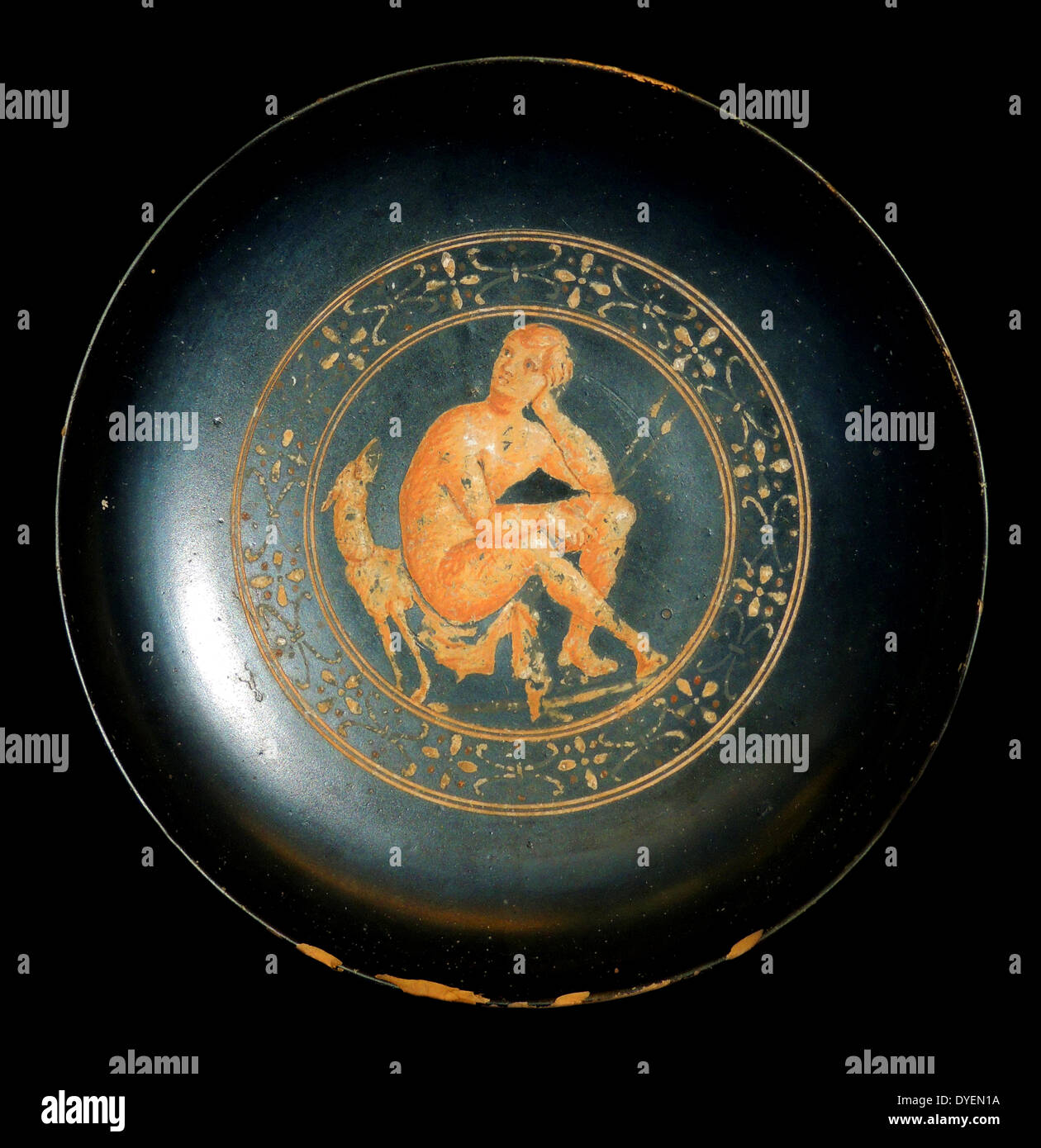 Black bowl painted in added colour showing a hunter seated on a rock with his dog beside him.  Probably made in southern Etruria.  About 300-280 BC. British Museum. Stock Photo