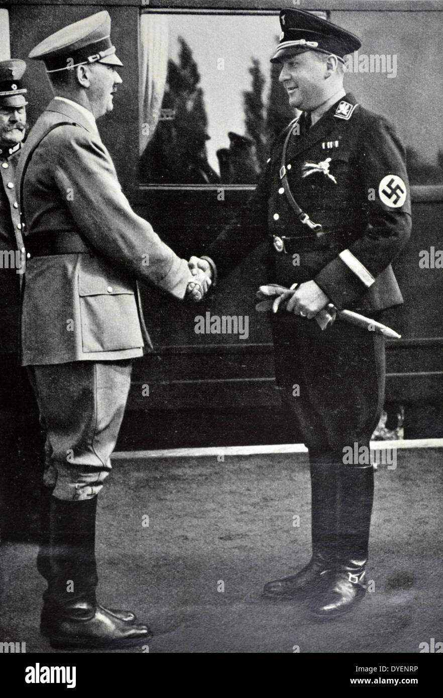Adolf Hitler is met by Richard Walther Darré (1895 – 1953) an SS-Obergruppenführer and one of the leading Nazi 'blood and soil' (German: Blut und Boden) ideologists. He served as Reich Minister of Food and Agriculture from 1933 to 1942. Stock Photo