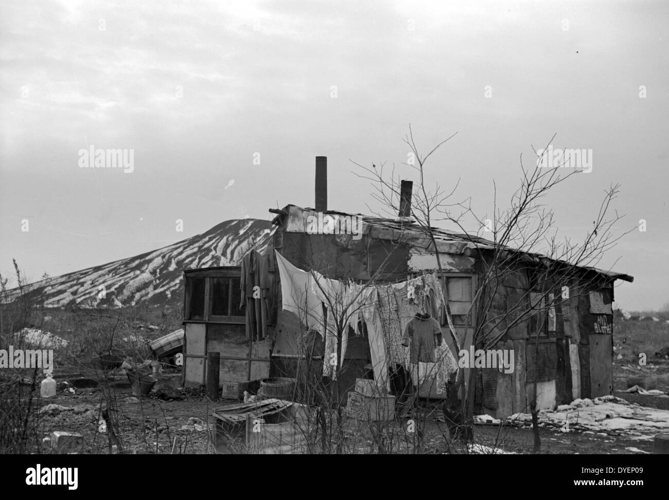 A shanty built of refuse near the Sunnyside slack pile, Herrin, Illinois Many residences in southern Illinois coal towns were built with money borrowed from building and loan associations. During the depression building and loan associations almost all went into receivership. Their mortgages were sold for whatever they would bring, and the purchasers demolished houses by the hundreds in order to salvage the scrap lumber. by Arthur Rothstein, 1915-1985, photographer Date 19390101. Stock Photo