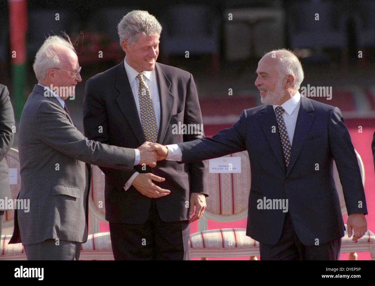 The Israel–Jordan peace treaty being signed in 1994. US President Bill Clinton watches Jordan's King Hussein and Israeli Prime Minister Yitzhak Rabin sign the treaty on the White house lawn Stock Photo