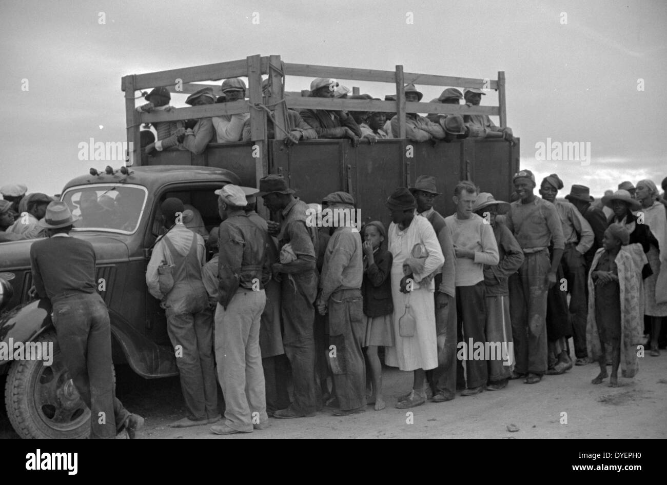 Vegetable workers, migrants, waiting after work to be paid. Near Homestead, Florida 19390101 Stock Photo