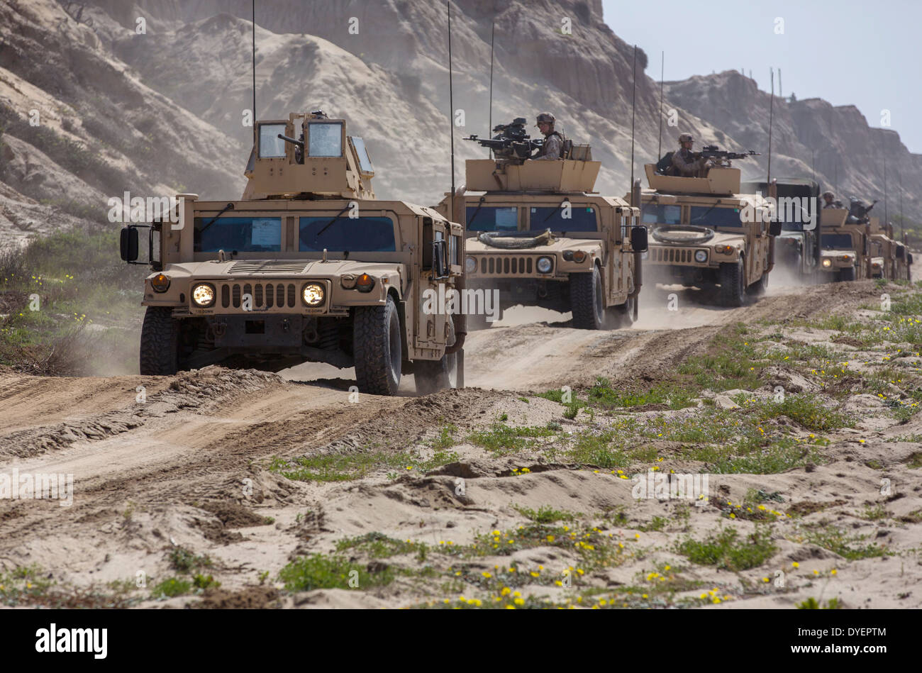 US Marines stage their armored HMMWV vehicles during a Marine Corps Combat Readiness Evaluation in simulated Afghan terrain March 17, 2014 at Camp Pendleton, California. The training tests the proficiency of Marines before upcoming deployments. Stock Photo