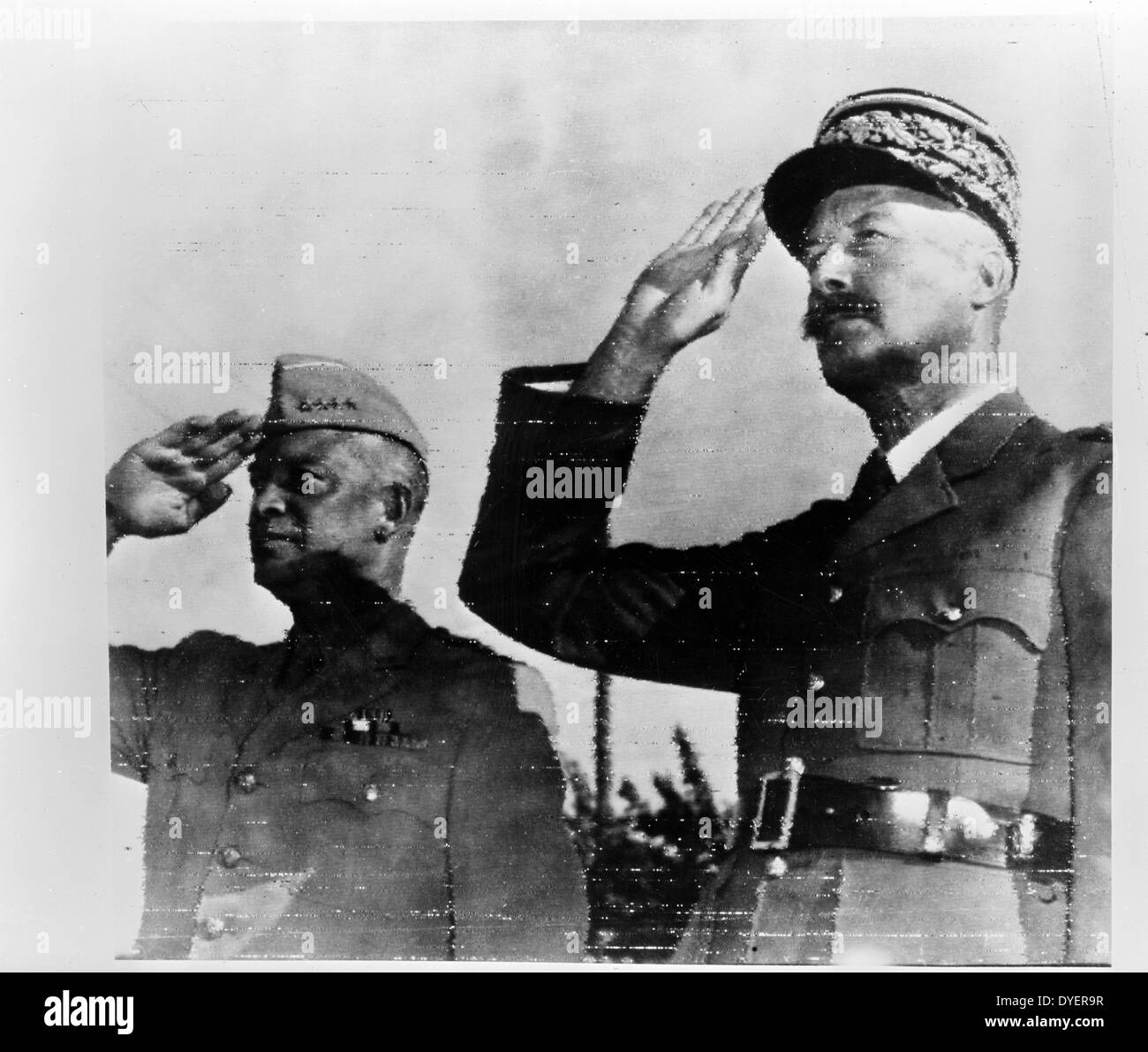 Algiers, Algeria. General Dwight D. Eisenhower, commander in chief of Allied Armies in North Africa, and General Honore Giraud, commanding the French forces, saluting the flags of both nations at Allied headquarters 19430101. Stock Photo