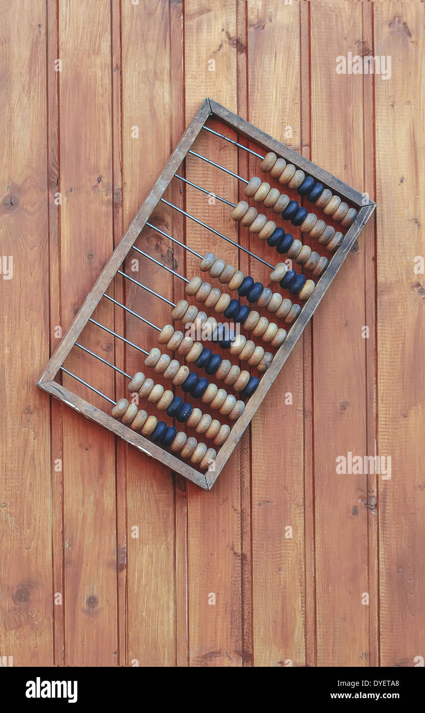 Nice wooden abacus on wooden wall in day Stock Photo