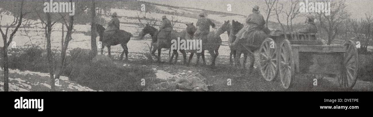 French cavalry soldiers with horses, carrying ammunition to the front line, halts as each soldier prepares his gas mask. France, Western Front, World War One 1916 Stock Photo