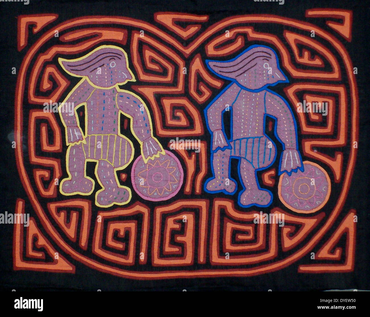Mola textile by Kuna Indian artist, depicting a modern influence on the Kuna culture. From the San Blas Archipelago, Panama.  Reverse applique design worn on female blouse. Two footballers. Stock Photo