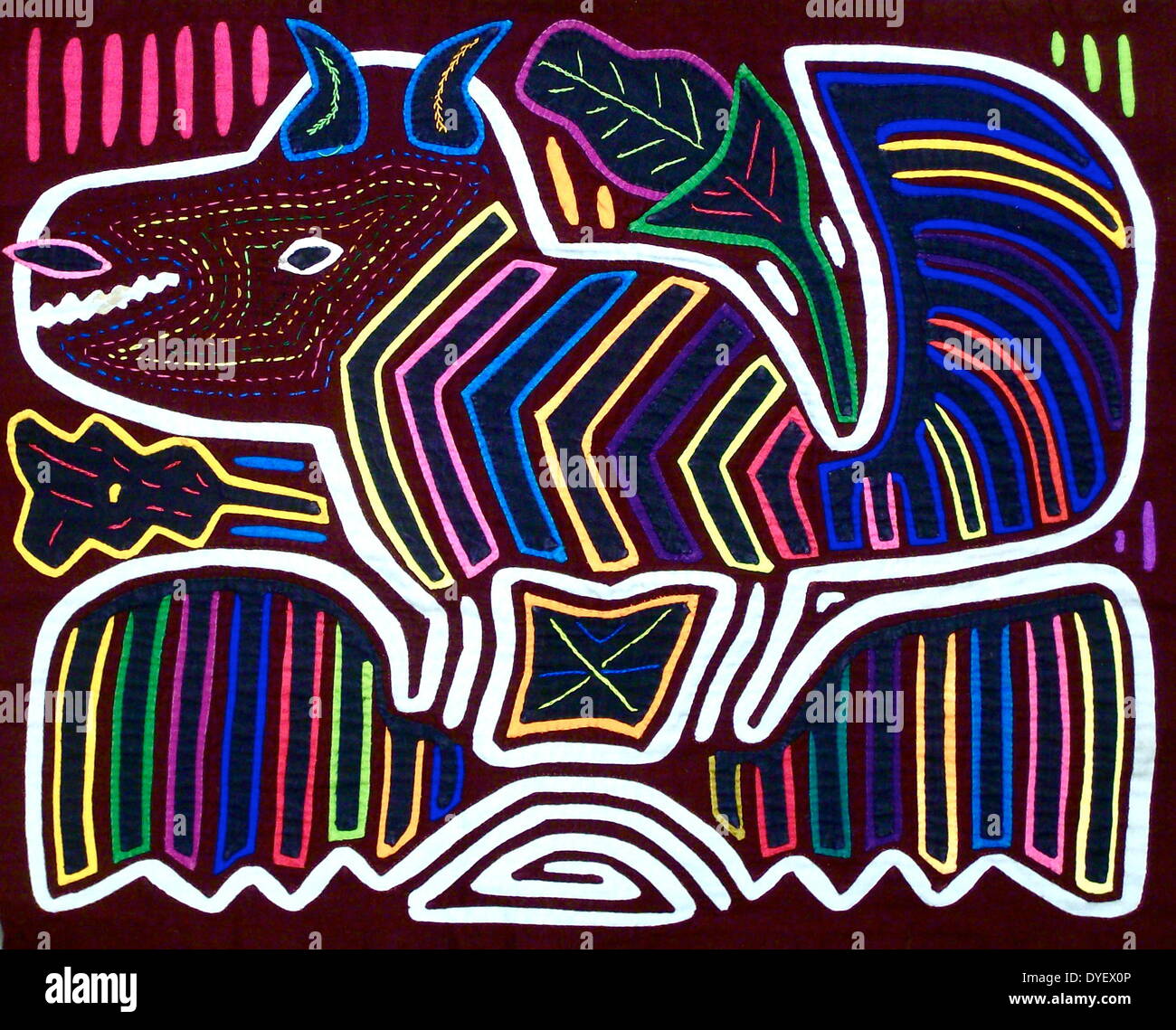 Mola textile by Kuna Indian artist, depicting a monster. From the San Blas Archipelago, Panama.  Reverse applique design worn on female blouse. 13 x 16 in. A horned devil monster. Stock Photo