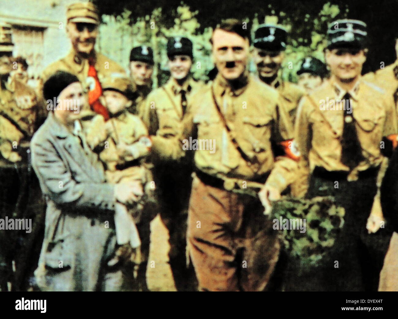 Hitler greets a German Nazi mother with child dressed in Nazi uniform circa 1932-33 Stock Photo