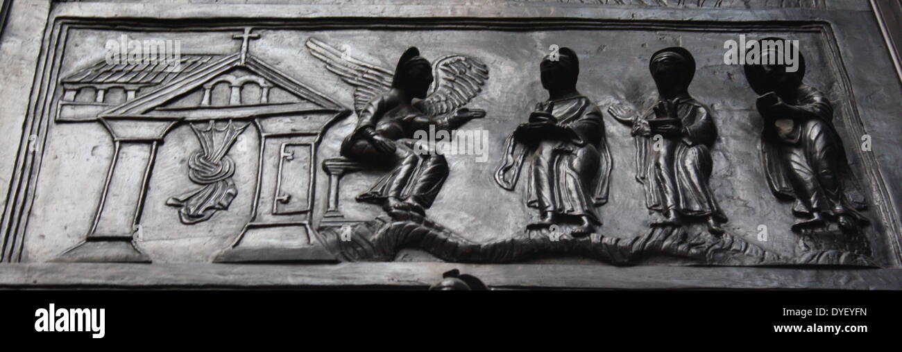 Detail from Bronze doors with scenes from the Old and New Testament in relief. Made at the order of St. Bernward, and set up by him in 1015 at St. Michael's Church, Hildesheim. They were since taken to the cathedral by his successor. This panel shows the Maries at the Sepulchre. Stock Photo