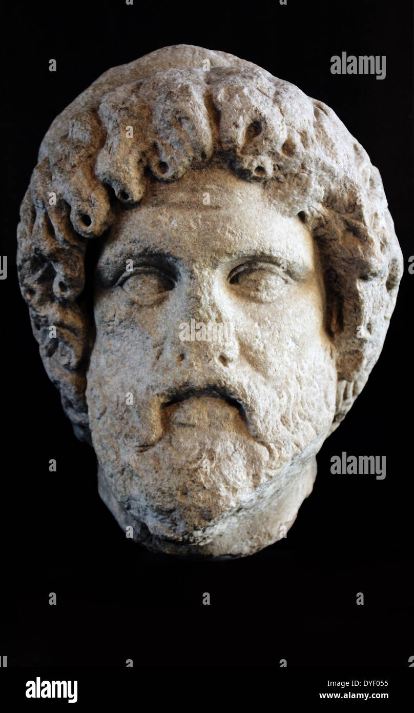 Marble head of a man with thick waving hair and deeply drilled curls. Identified as Asclepius. Made between late 2nd century and early 3rd century AD. Roman. Stock Photo