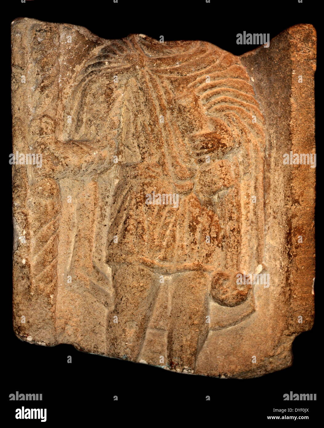 Relief image of a learned man, found in the Roman Baths. Circa 1st-3rd century AD. Shown holding a scroll indicating he is educated. The head is missing from deterioration. Stock Photo
