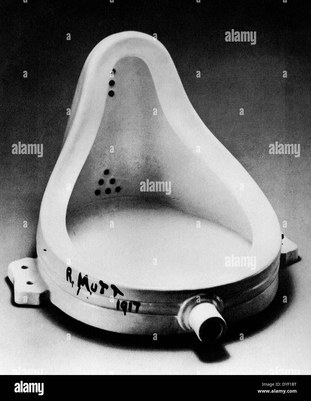 Photograph of an early example of 'Dada' art. A urinal 'readymade', signed with a joke name. Circa 1917. Stock Photo