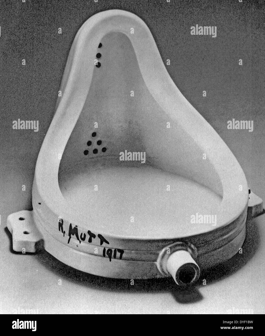 Photograph of an early example of 'Dada' art. A urinal 'readymade', signed with a joke name. Circa 1917. Stock Photo