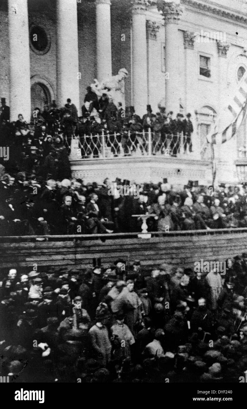 President Abraham Lincoln delivering second inaugural address in front of the United States Capitol, March 4, 1865. The crowd awaits the President's address. Lincoln still sits at left centre. On Lincoln's left are the justices of the Supreme Court; on his right, the members of his cabinet. At his immediate right, is Andrew Johnson; and, next to Johnson, looking towards the cameraman, is the outgoing Vice President Hannibal Hamlin. Stock Photo