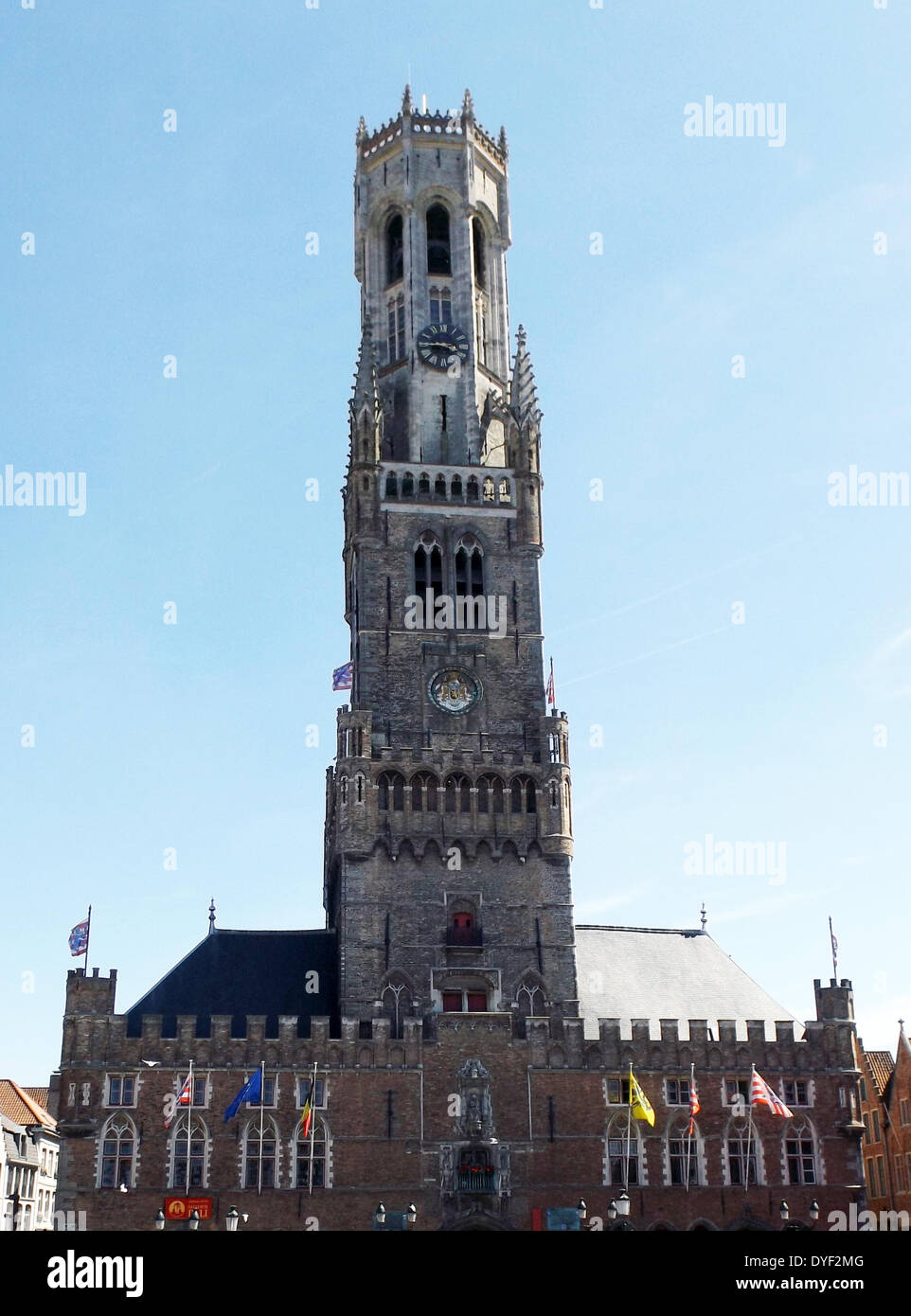 The belfry of Bruges, or Belfort, is a medieval bell tower in the historical centre of Bruges, Belgium. One of the city's most prominent symbols, the belfry formerly housed a treasury and the municipal archives, and served as an observation post for spotting fires and other danger. A narrow, steep staircase of 366 steps, accessible by the public for an entry fee, leads to the top of the 83-metre-high building, which leans about a metre to the east. Stock Photo