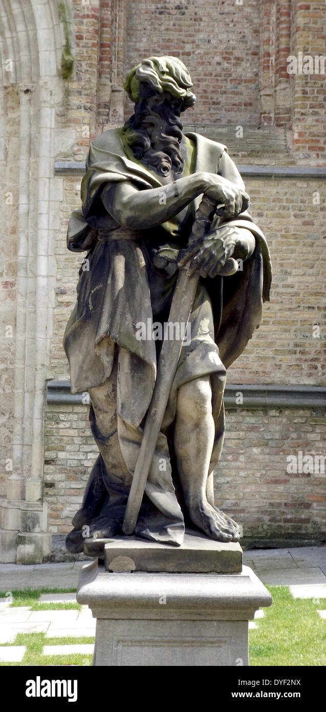 Statue of a saint, in the grounds of the The Sint-Salvator Cathedral, (Saint Saviour), is the main church of the city of Bruges in Belgium. The oldest surviving part, dated from the 12th century, formed the base of the mighty tower. Stock Photo