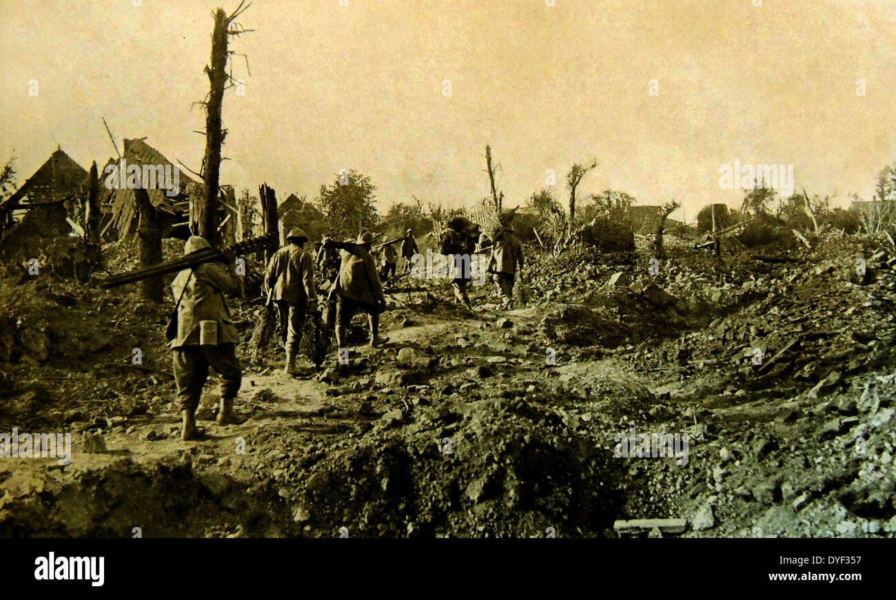 the remains of Dompierre as French forces pass through. France, world war one. 1916 Stock Photo