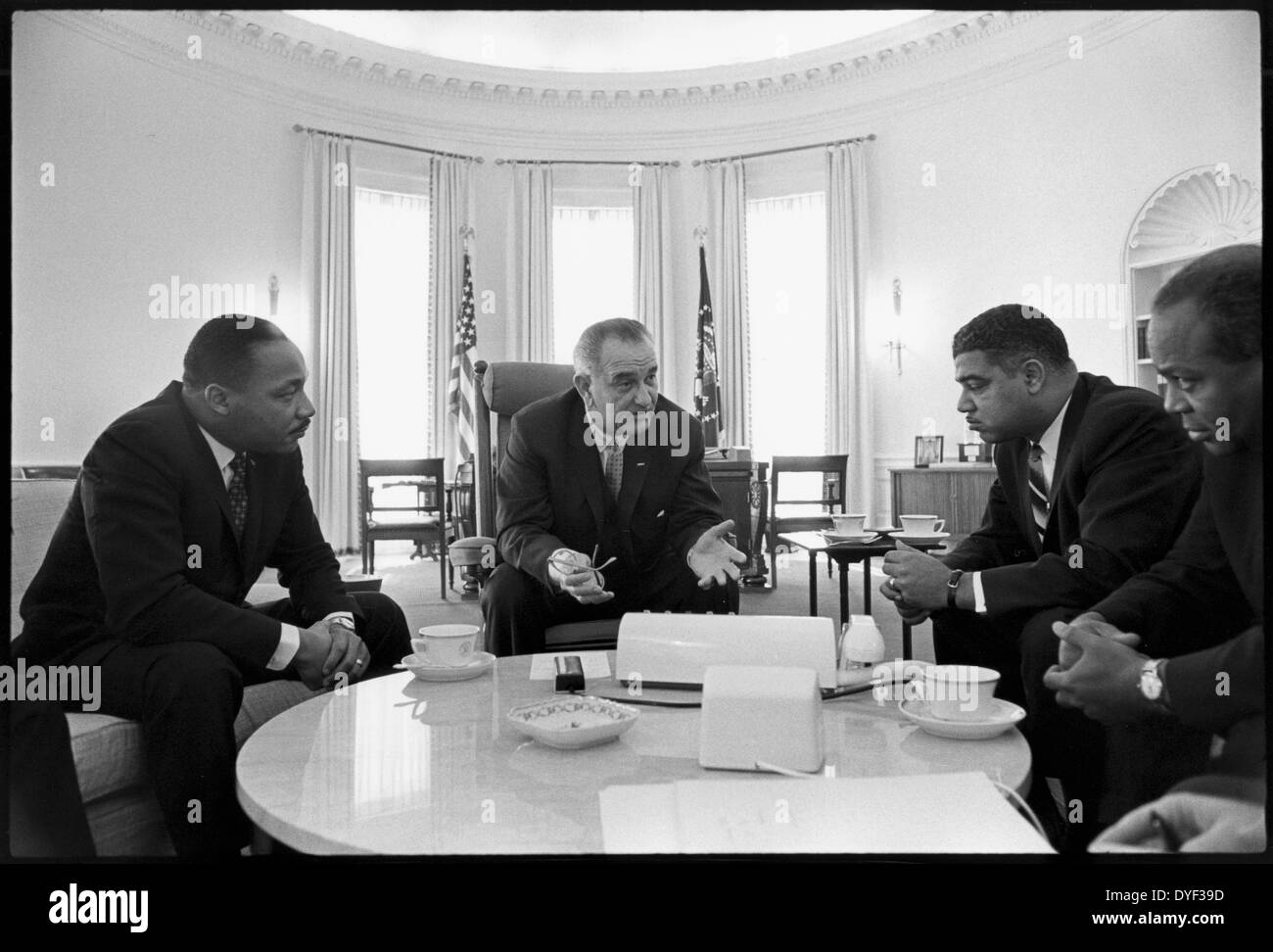 Photograph of (left to right) Martin Luther King J.r, President Lyndon Johnson and James Abernathy leaders in the Oval Office discussing the Civil Rights Movement. 1964 Stock Photo