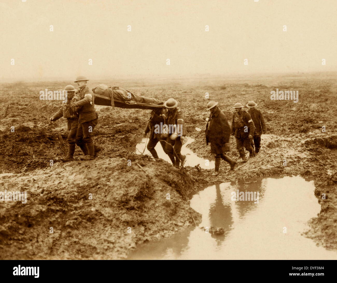 Canadians Wounded  at the Battle of Passchendaele. This photograph shows a Canadian solider being carried by Stetcher-Bearers through shell holes to the wounded aid post. Unknown Stock Photo