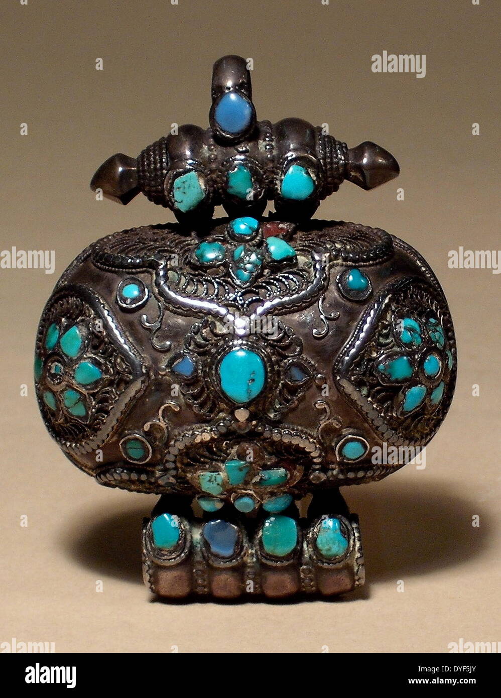 Ancient Tibet: Gau pendant. A prayer-box worn as jewellery. Decorated with Tibetan silver and turquoise. Stock Photo