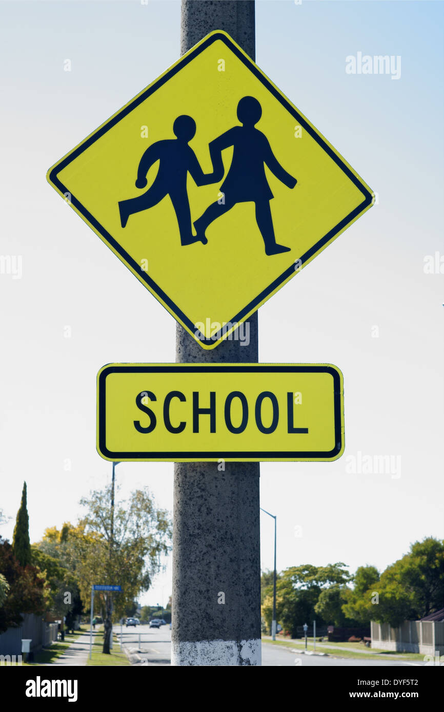 School crossing sign warning drivers they are entering a school zone Stock Photo