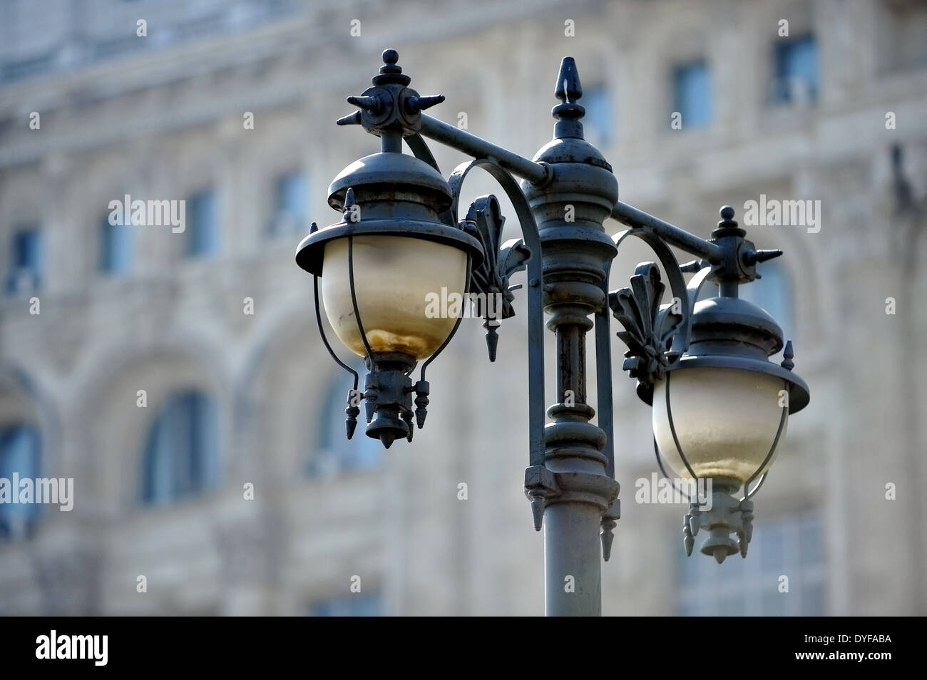 Outdoor public lighting pole with building on background Stock Photo