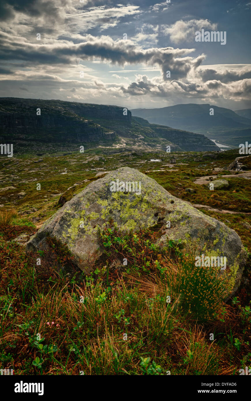 Majestic morning views in Sirdalen, Vest-Agder, Norway, with a prominent rock in the foreground. Stock Photo