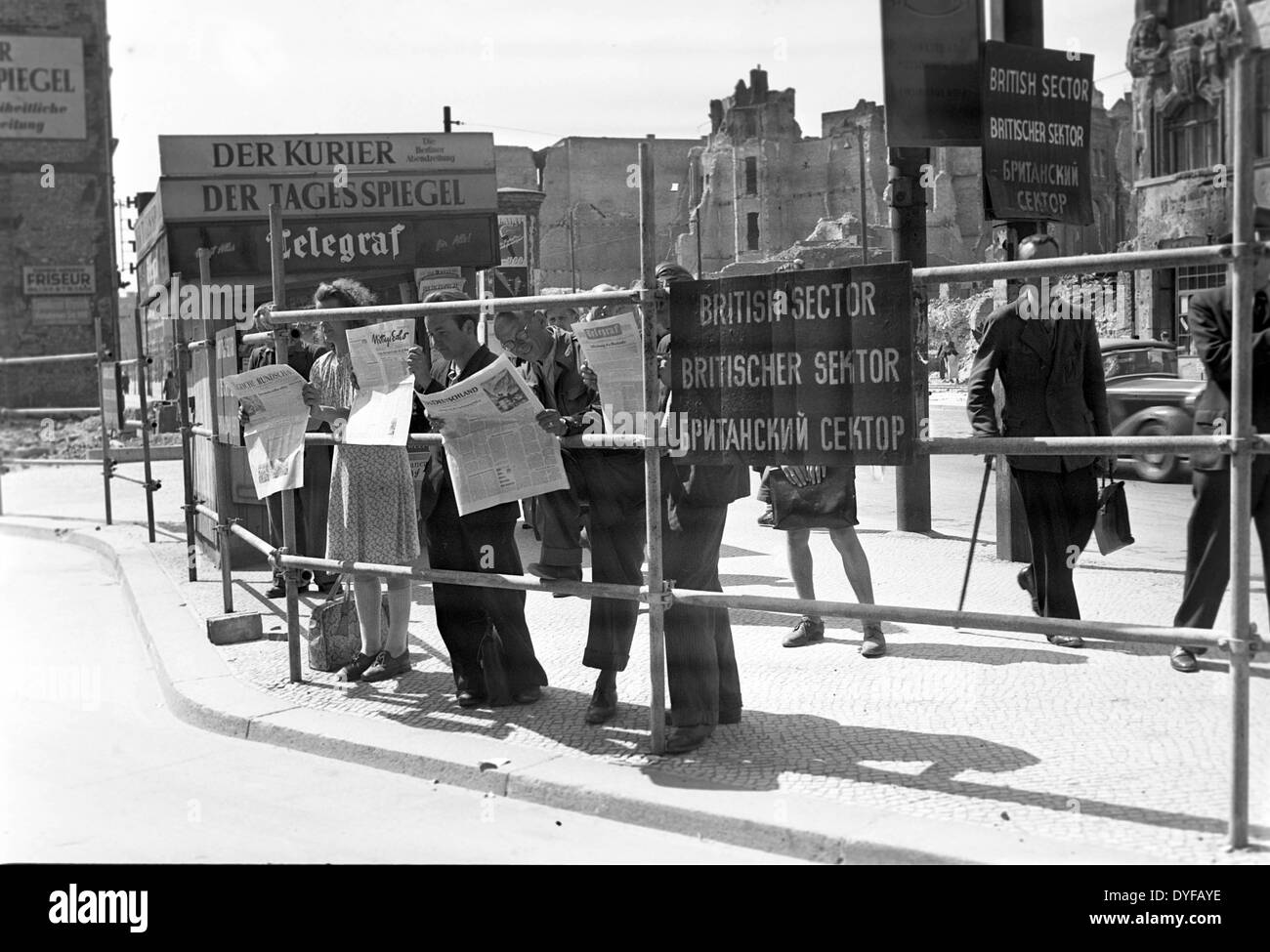 The end of the Berlin Blockade - West Berlin citizens are reading about the  announced lifting of the Berlin Blockade in the daily news, at the border  between the British and the