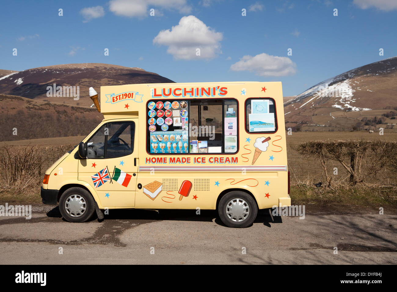 An Ice cream van parked at Castlerigg near Kewsick in the English Lake District, with snow still lying on the hills Stock Photo