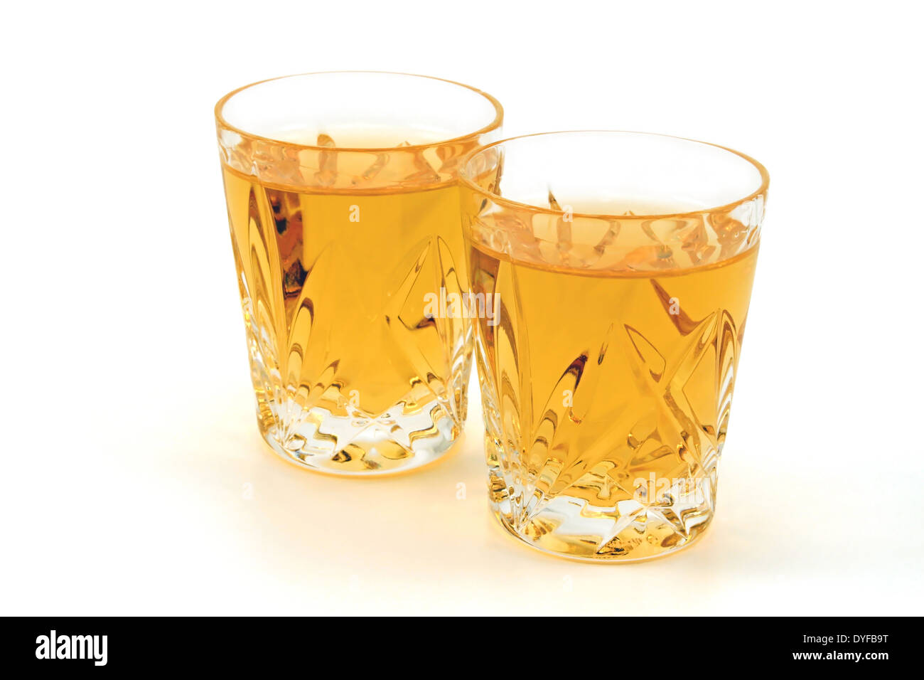 Two shot glasses of whiskey against a white background Stock Photo