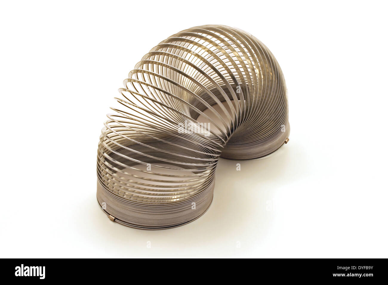 A silver spring coil toy against a white background Stock Photo