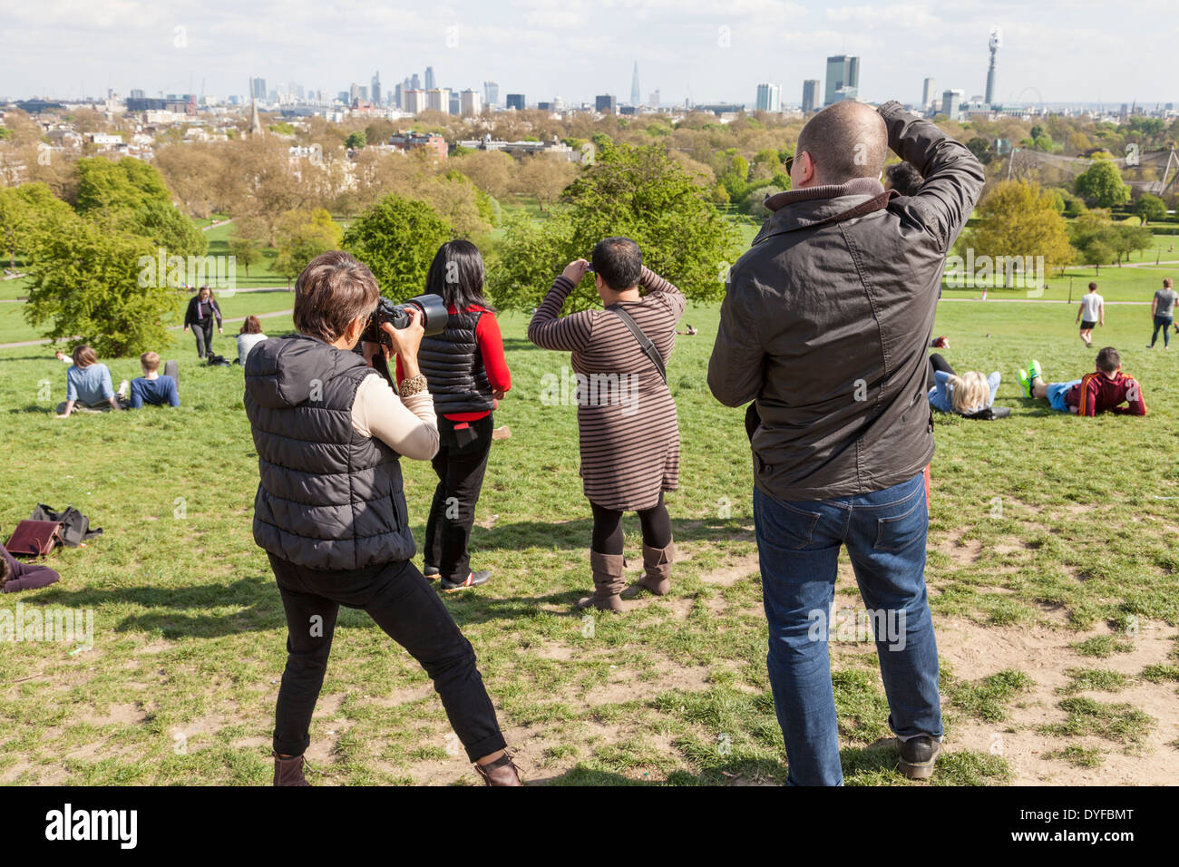 Photo opportunity. People taking photos of the London city skyline from Primrose Hill, London, England, UK Stock Photo