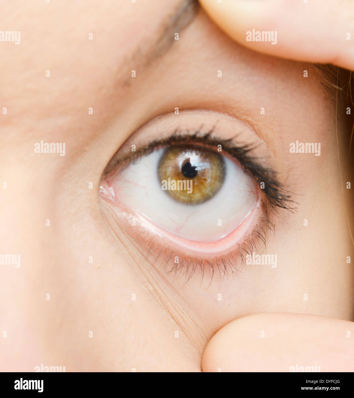 woman opened eye with fingers Stock Photo - Alamy