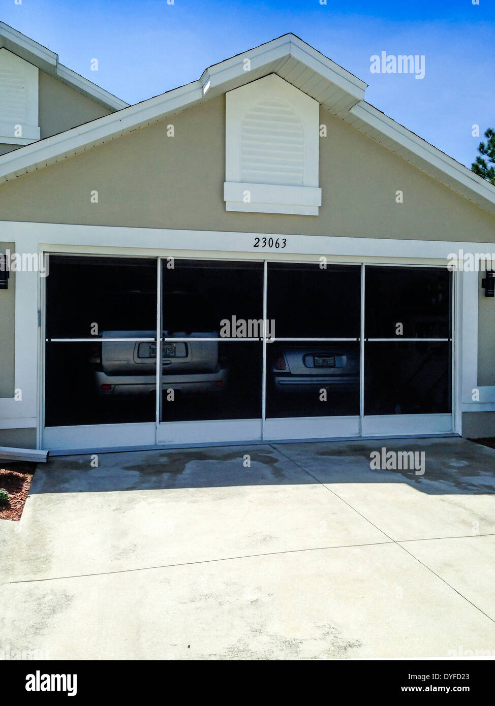 Florida home with sliding garage screens allowing air to circulate